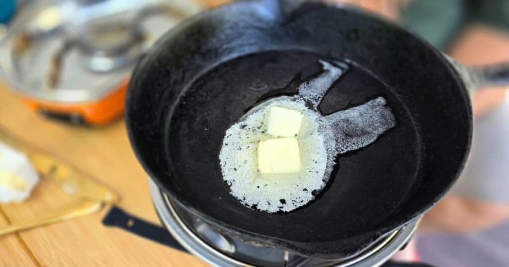 family camping meals BUTTER IN A CAST IRON SKILLET