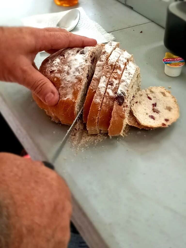 Freshly baked cranberry walnut artisan bread cooling on a wire rack.