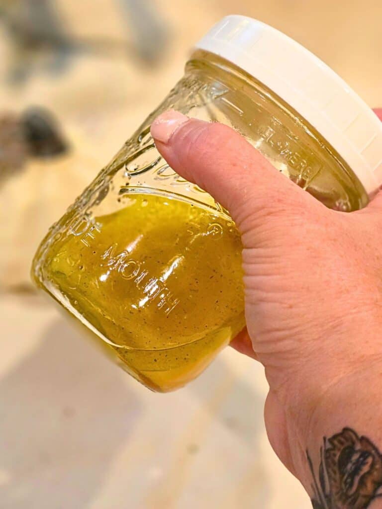 shaking homemade citrus vinaigrette in jar