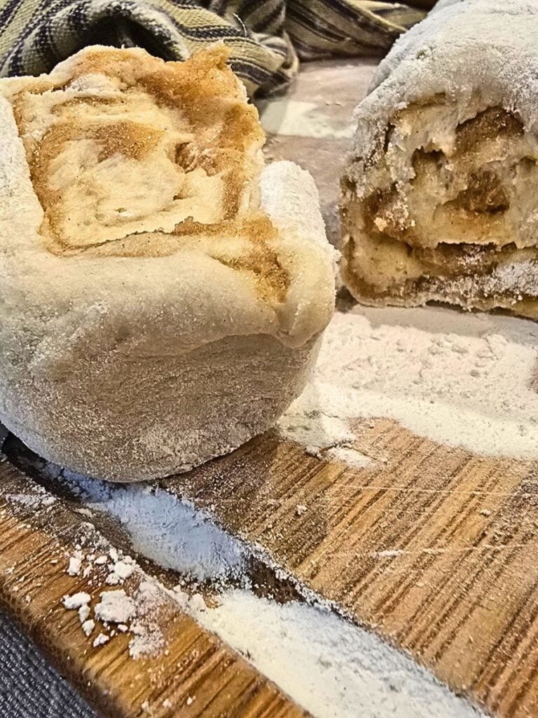 homemade cinnamon rolls being sliced