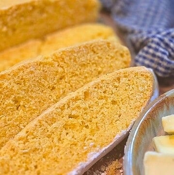 sliced homemade cornmeal bread with butter