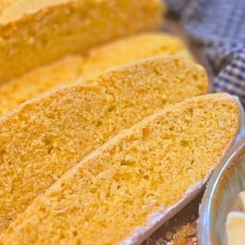sliced homemade cornmeal bread with butter