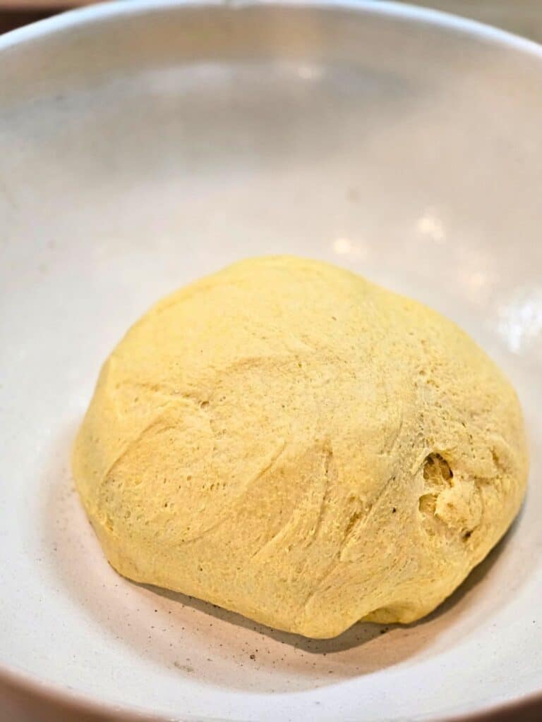 yeast dough rising in mixing bowl