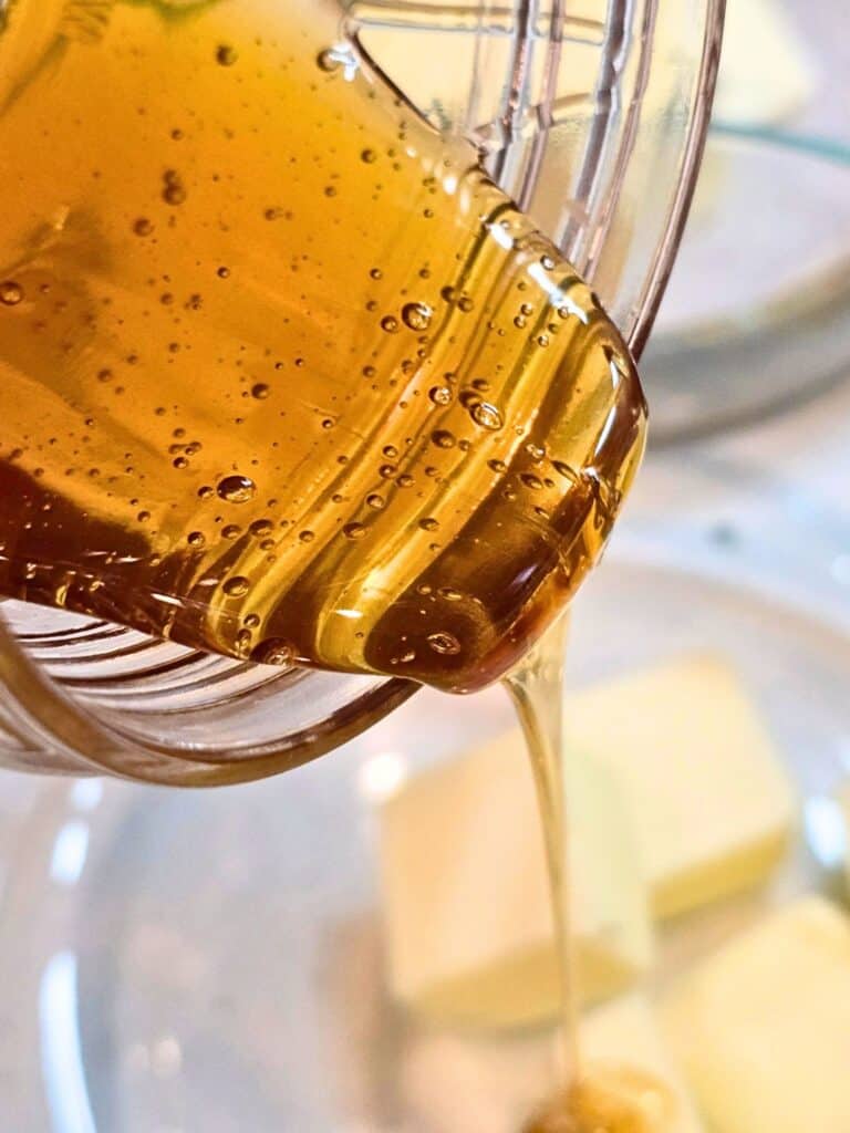 pouring honey into homemade bread dough