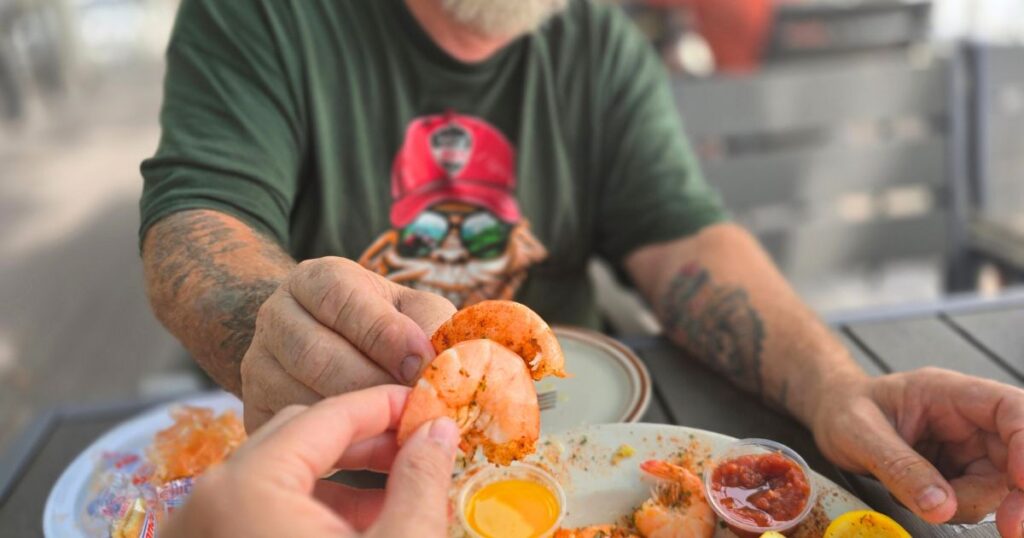 THIS IS AN IMAGE OF CHEERING WITH BOILED SHRIMP AT AUNT KATES IN ST. AUGUSTINE