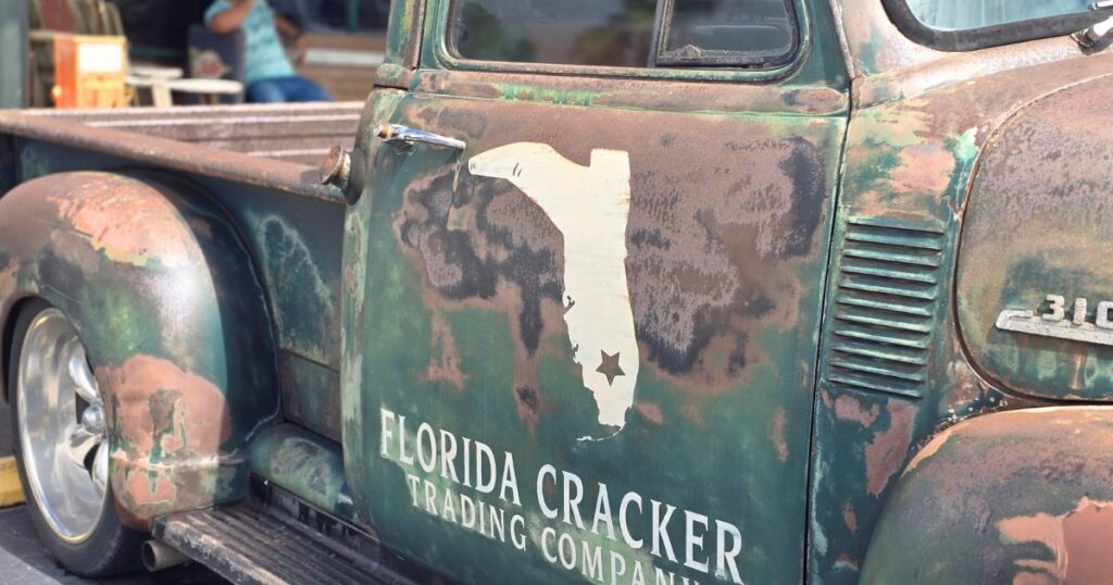Florida Cracker vintage truck with rusted patina and Florida map logo, part of The Wandering Hulasquatch collection.