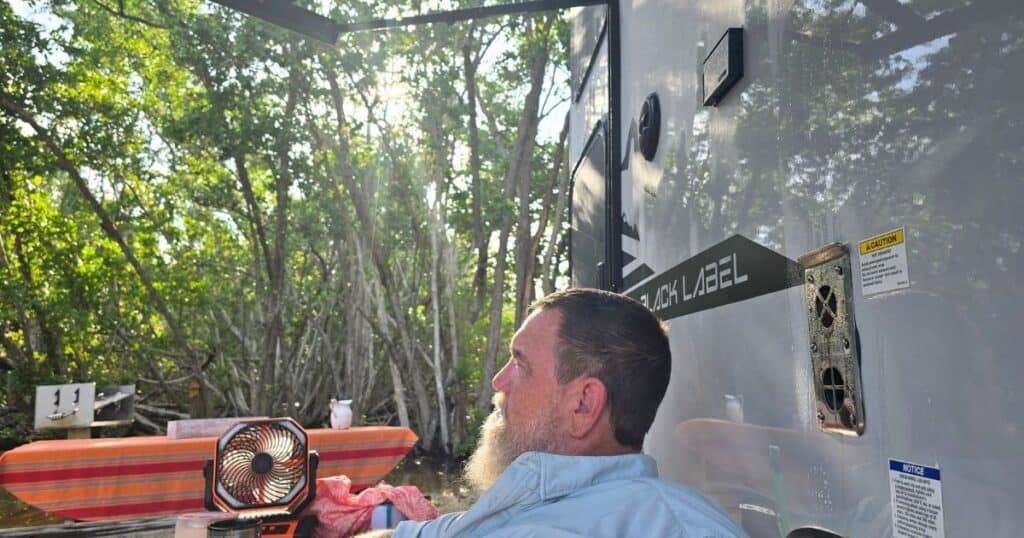 MAN ENJOYING CAMPSITE