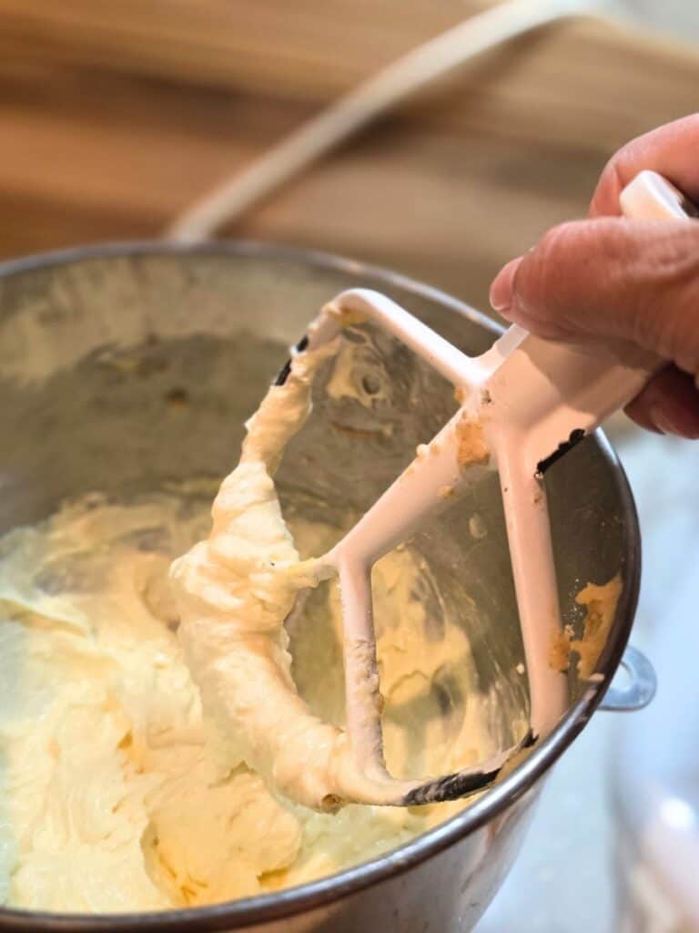 Mixing butter and brown sugar to make the graham cracker base for baked s’mores bars