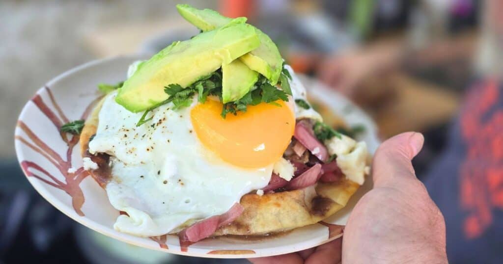 Tender shredded mojo pork served on a crispy breakfast tostada with fresh toppings